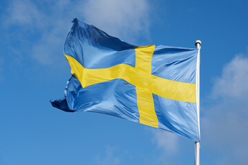 Flag of Sweden against a blue sky.