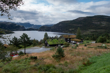 Traditional norwegian wooden houses with grass on the roof