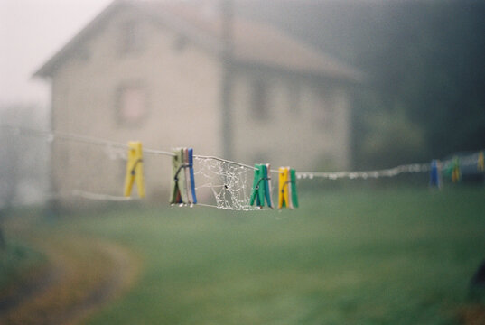wet laundry line in front of farmhouse