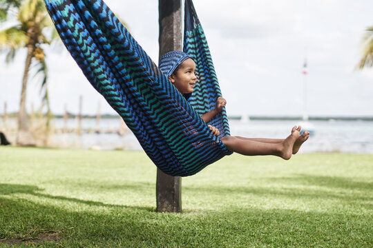 Young boy on vacation swinging in a hammock