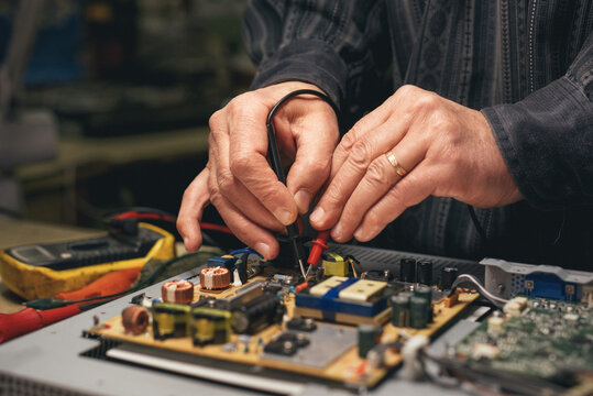 Technician probing a circuit board