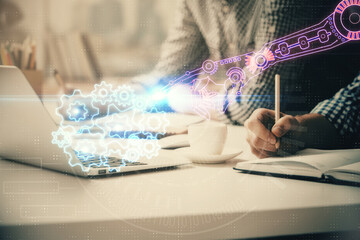 Fototapeta premium Businessman with computer background with technology theme hologram. Concept of hightech. Multi exposure.