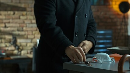 Covid-19 virus danger - Man in coat getting covid19 protective mask before leaving safety of home. 