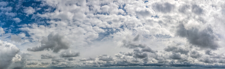 Fantastic clouds against blue sky, panorama