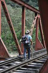 Obraz na płótnie Canvas Hikers walking alongside the railroad tracks that lead to Aguas Calientes, the gateway to Machu Picchu, in Peru