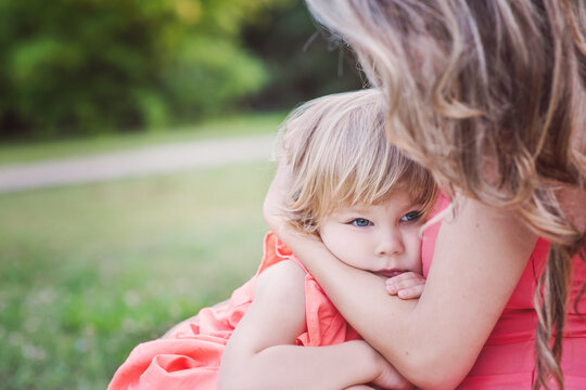 Cute little girl snuggling with her mother