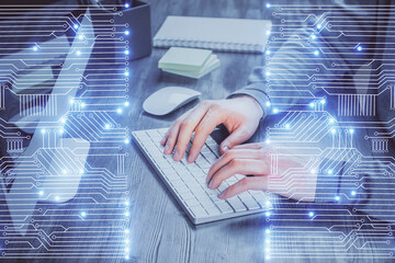 Technology theme hologram with man working on computer on background. High tech concept. Double exposure.