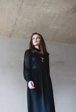 Portraits of a beautiful young woman in a vintage black dress