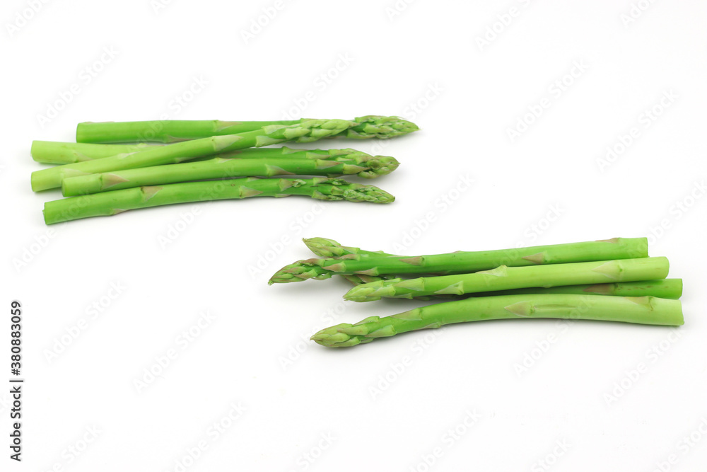 Wall mural Green asparagus on a white background