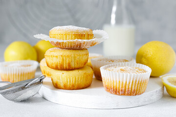 Obraz na płótnie Canvas Lemon muffins with sugar powder