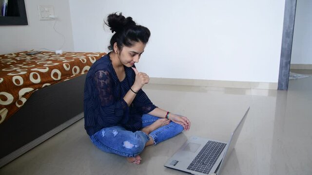 deaf-mute Girl talking using sign language during video call online on laptop in domestic room. Hearing impaired friends chatting online via video conference using computer 