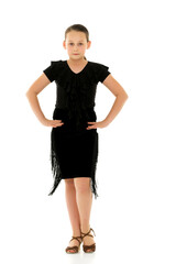 A cheerful little girl is dancing.The concept of a school of dance.