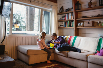 Grandma and child playing games on couch inside during winter