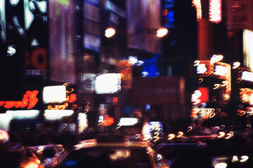 Blurred nighttime view of traffic and lights in Times Square, NY, NY, USA