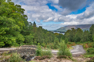 Fototapeta na wymiar Stunning long exposure landscape image of Ashness Bridge in English Lake District during late Summer afternoon with dramatic lighting