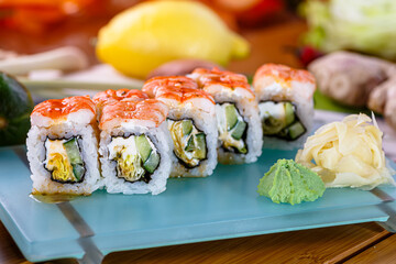 Hosomaki sushi rolls with shrimp, Philadelphia cheese and cucumber are on a plate