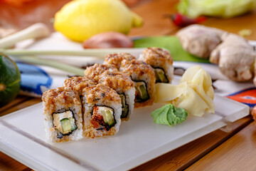 Hosomaki sushi rolls with eel, Philadelphia cheese and cucumber are on a plate