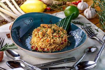 Rice with vegetables and chicken on a plate, Asian cuisine