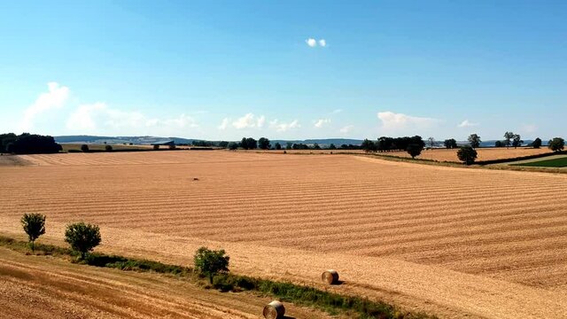 Slow upwards moving drone shot of wheat fields, near small village Taize in France.