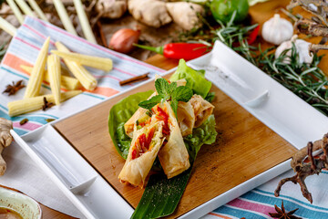 Spring rolls with vegetables and sauce are on the plate