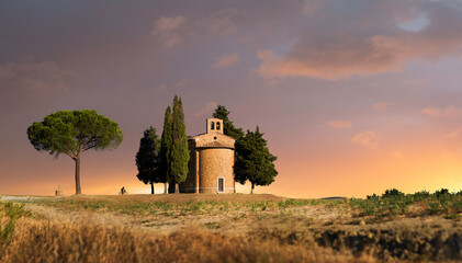 Sunrise after the storm - Chapel in between trees in Tuscany, Italy