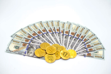 Gold Bitcoin on hundred dollars bills.