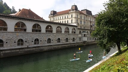 Stand up paddlers on the Ljubljanica, Ljubljana, Slovenia