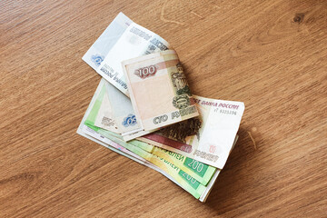Moscow, Russia: 06/09/2020 - Russian money / banknotes on a wooden table.
