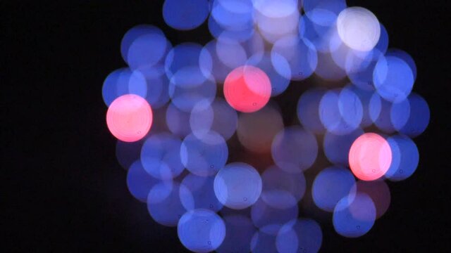 This is a slow motion video of very big fireworks going off out of focus