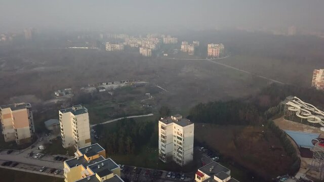Flying over a concrete living apartment area in east Europa with many birds flying around the drone
