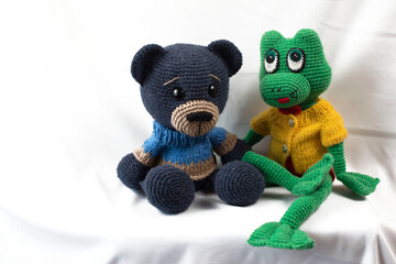 Handmade amigurumi dolls Bear hare giraffe frog donkey posing for the photographer.