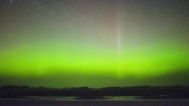 colorful northern lights (aurora borealis) seen from swamp marsh bird reserve timelapse