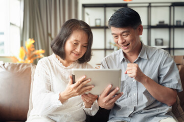 Scene couple of Asian elderly make a video conference call by smartphone during self isolation at home while covid19 epidemic.