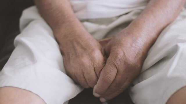 Cinematic shot Closeup of an Elderly man's hands holding a cane.