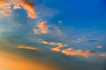 Beautiful yellow clouds in blue sunset sky