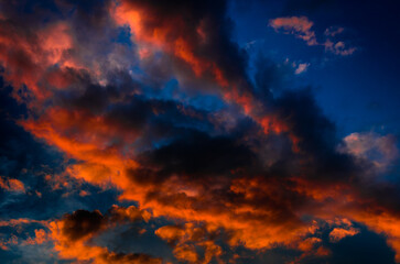 Beautiful sunset. Red clouds in the dark sky