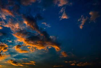 Beautiful sunset. Orange clouds in the dark blue sky