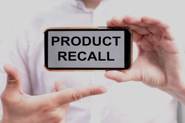 Product Recall. Businessman holding a phone with a message text written on it. Business concept