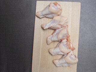 raw chicken on a wooden board