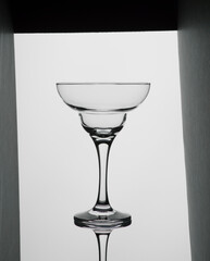 Glass for champagne and cocktail on a white background in a frame