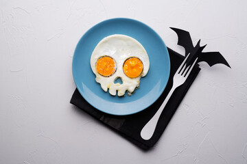 Fried eggs in the shape of a skull. Halloween breakfast.