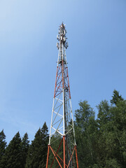 high cell tower against the blue sky