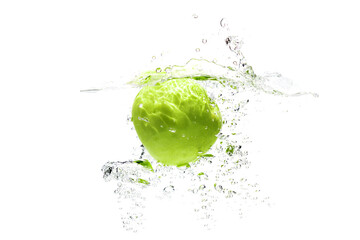 one green apple falling into water on a white background with splashes, drops and bubbles.