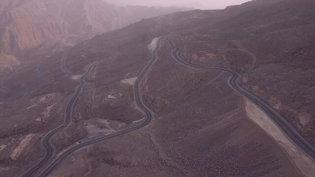 Magnificent drone view over twisted road in Ras Al Khaimah mountains/UAE.