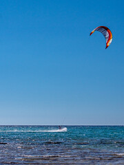 Kite Surfing through the afternoon sun with silhouette contours