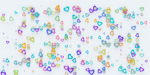 Colorful paper heart scattered on white background.