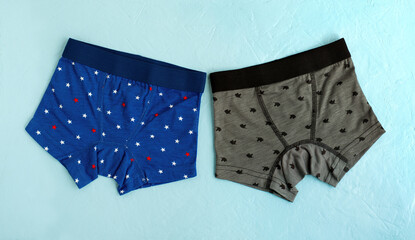 Underwear for a boy in the form of a set of panties. Briefs for the child in the form of shorts. Baby underwear on a textured background. Pants made of soft jersey.