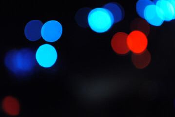 Bokeh traffic light at night in the street of a big city