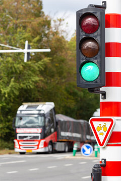 Truck passing a road intersection at a green light of a traffic signal