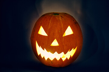 halloween pumpkin with light bulb and backlit scary zigzag muzzle. hedgehog. High quality photo